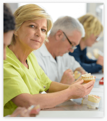 Denture Model woman holding a denture model
