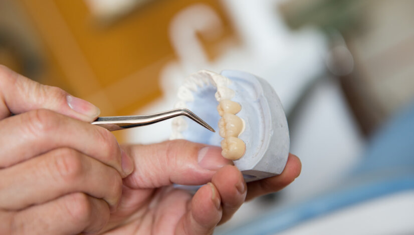 denturist repairing a pair of dentures