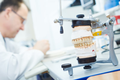 denturist working to repair a denture