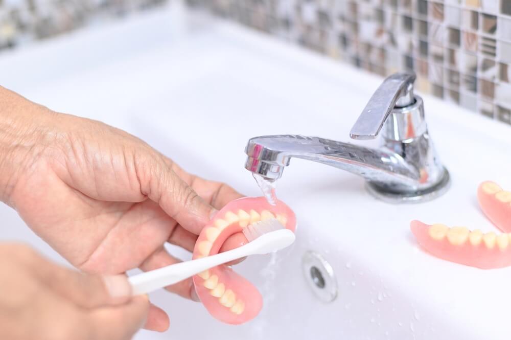 Is it OK to sleep with dentures?