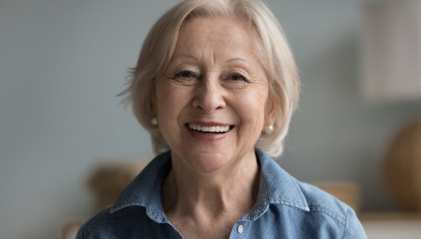 Smiling Retired Woman - How Do Dentures Stay in Place