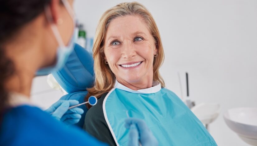 Smiling senior woman looking at dentist
